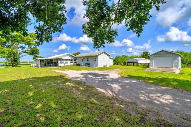 view of yard with an outbuilding, a carport, and a garage