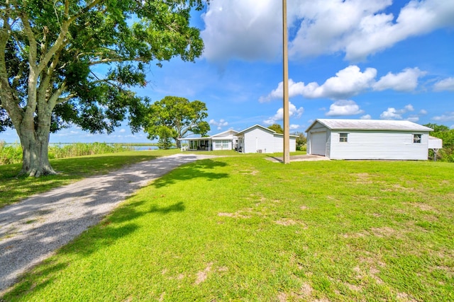 view of yard with a garage and an outdoor structure