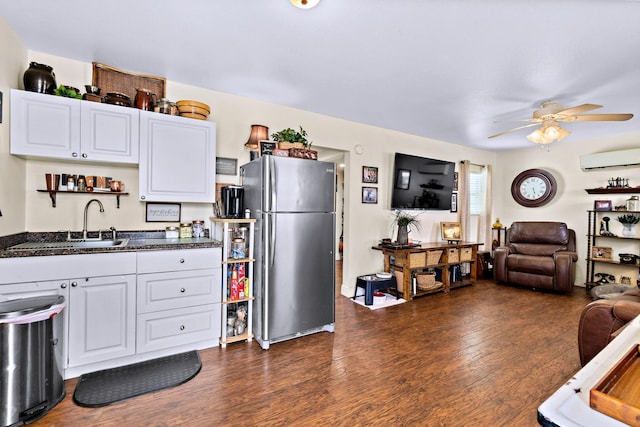 kitchen featuring sink, white cabinetry, stainless steel refrigerator, dark hardwood / wood-style floors, and ceiling fan