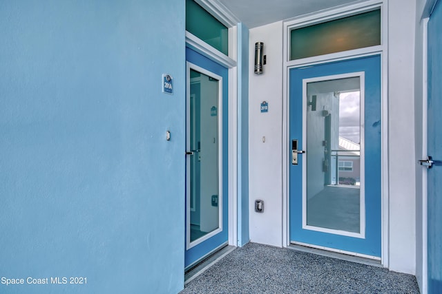 entrance to property with stucco siding
