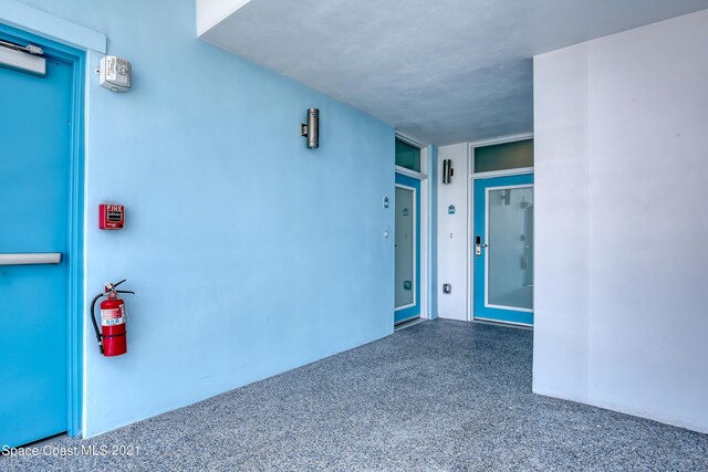 doorway to property featuring stucco siding