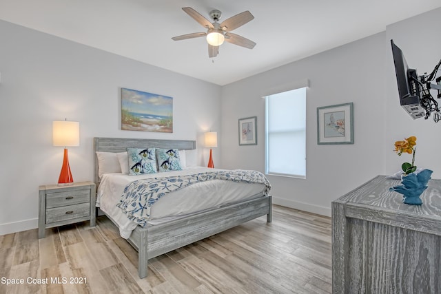 bedroom with baseboards, ceiling fan, and wood finished floors