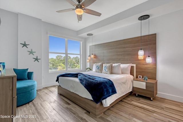 bedroom with baseboards, light wood-style floors, and a ceiling fan