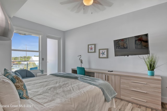 bedroom with light wood-style floors and a ceiling fan