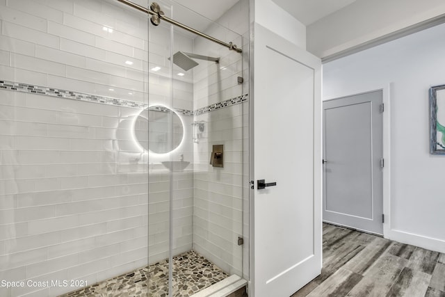 bathroom featuring a stall shower and wood finished floors