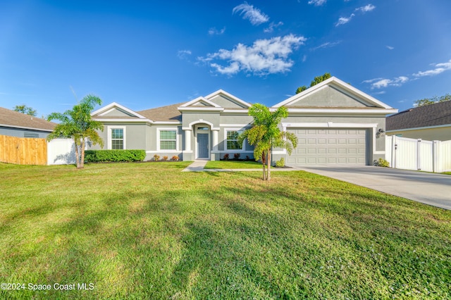 ranch-style house featuring a front yard and a garage