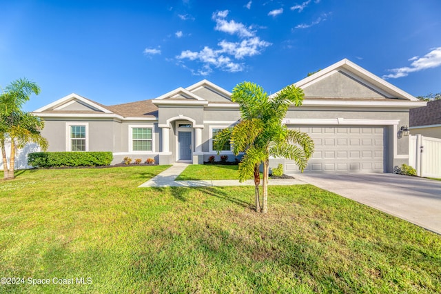 ranch-style house featuring a front lawn and a garage