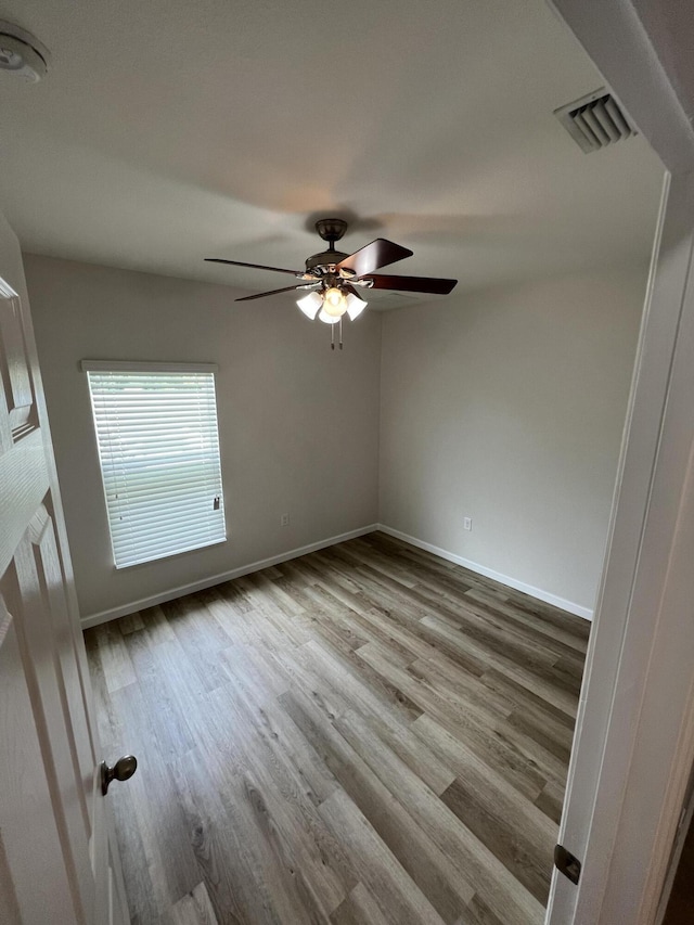 spare room featuring light wood-type flooring and ceiling fan