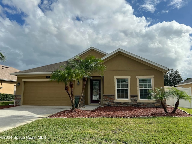 view of front of house featuring a front lawn and a garage