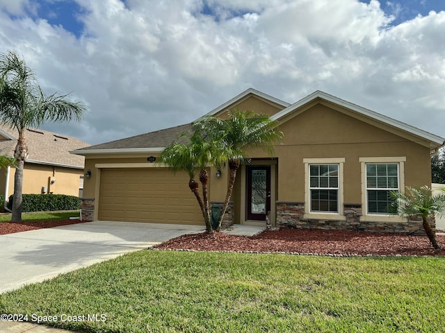 view of front of property with a garage and a front yard