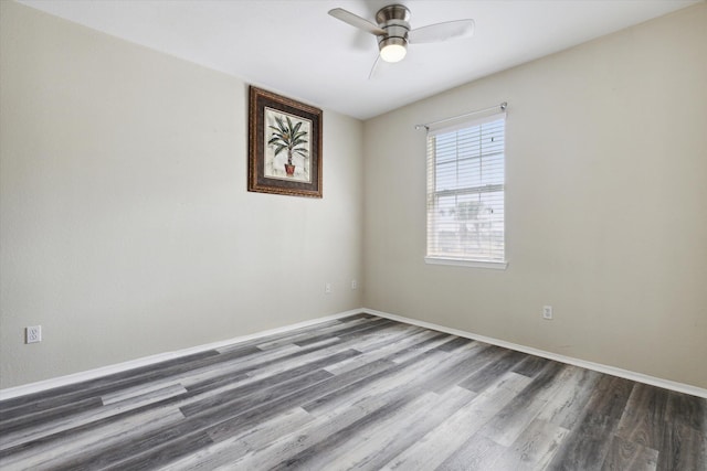 empty room with dark hardwood / wood-style floors and ceiling fan