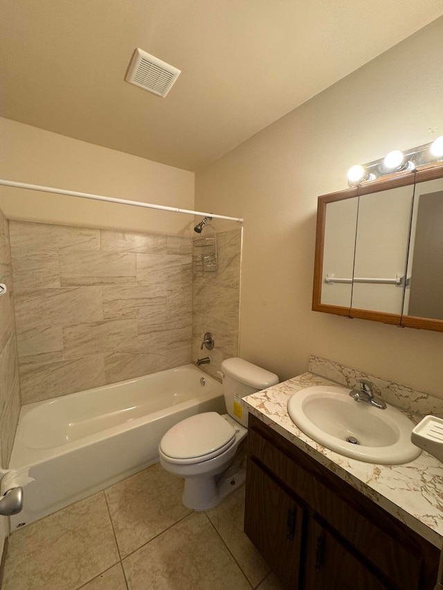 full bathroom with tile patterned floors, toilet, vanity, and tiled shower / bath