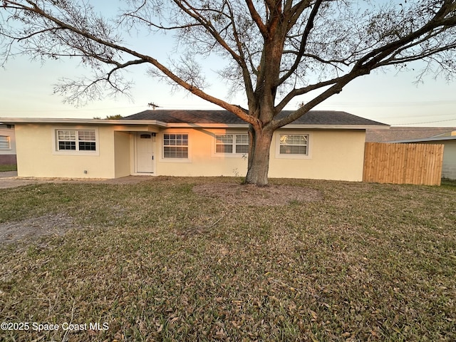 rear view of house featuring a yard