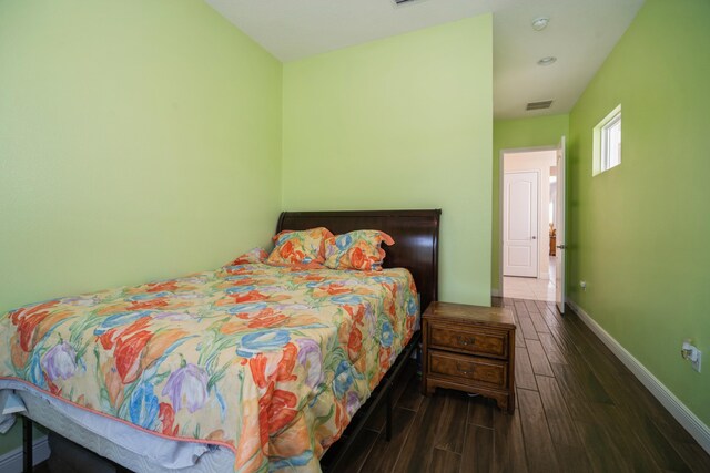 bedroom featuring dark hardwood / wood-style flooring