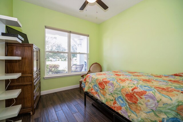 bedroom with dark hardwood / wood-style flooring and ceiling fan