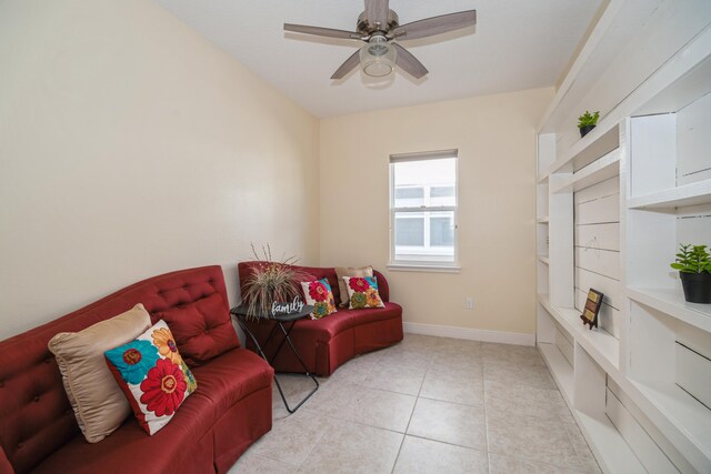 sitting room featuring light tile patterned flooring and ceiling fan