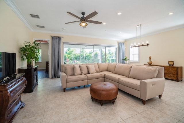 living room featuring ornamental molding, ceiling fan with notable chandelier, and light tile patterned floors