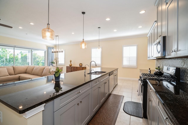 kitchen with gray cabinets, sink, and tasteful backsplash