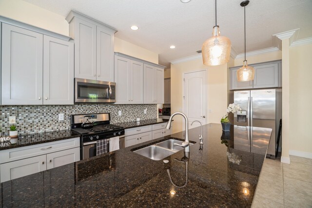 kitchen featuring sink, decorative backsplash, dark stone counters, and stainless steel appliances