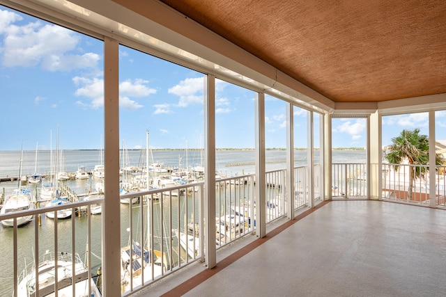 unfurnished sunroom with a water view