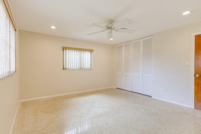 unfurnished bedroom featuring a closet, ceiling fan, and multiple windows