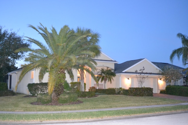 view of property hidden behind natural elements with a front yard