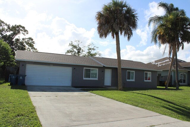 ranch-style home featuring a garage and a front lawn