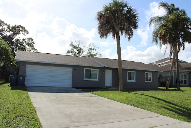 single story home featuring a garage and a front lawn