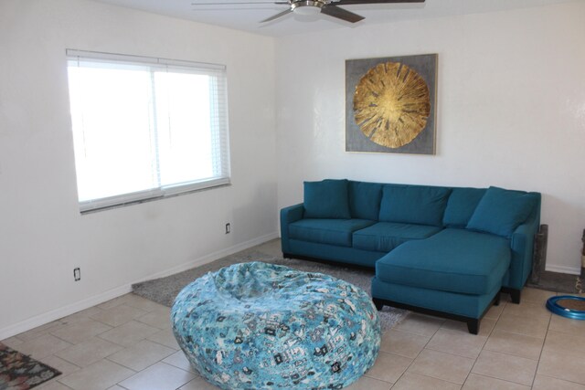 tiled living room with ceiling fan