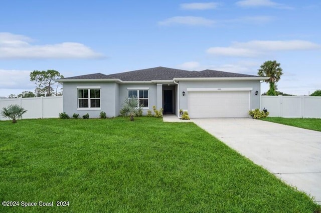 view of front of home featuring a garage, driveway, a front yard, and fence