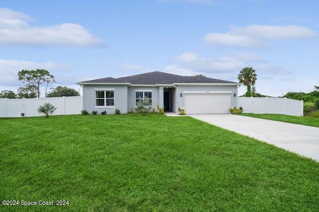 view of front of home with a front lawn and a garage