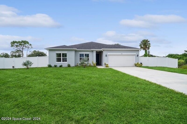 view of front of home featuring stucco siding, driveway, fence, a front yard, and an attached garage