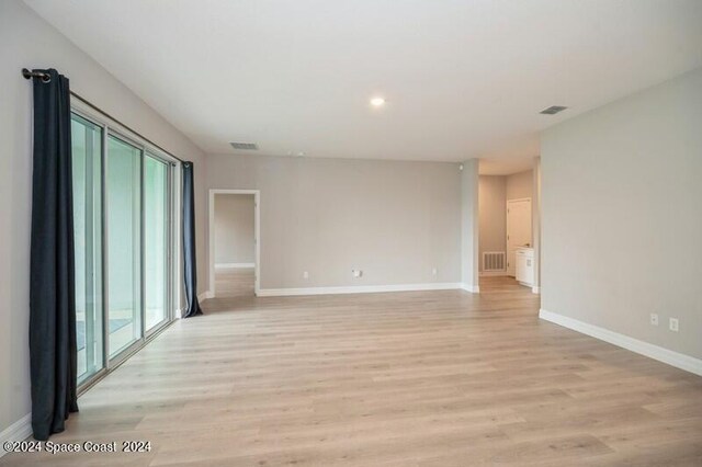 empty room featuring plenty of natural light and light hardwood / wood-style flooring