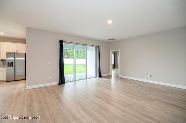 unfurnished living room with light hardwood / wood-style flooring