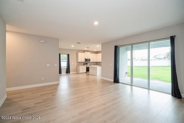 unfurnished living room with light hardwood / wood-style floors