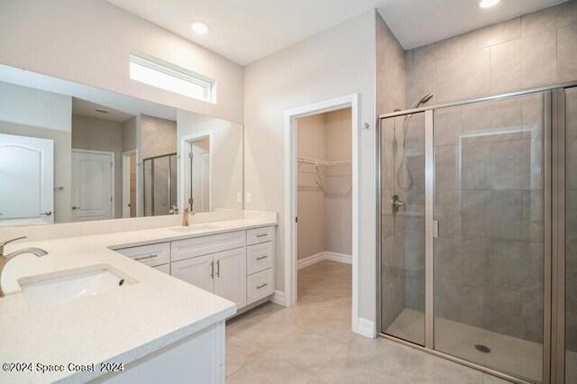 bathroom with vanity, an enclosed shower, and tile patterned floors