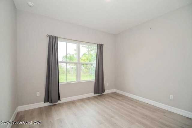 spare room with light wood-type flooring