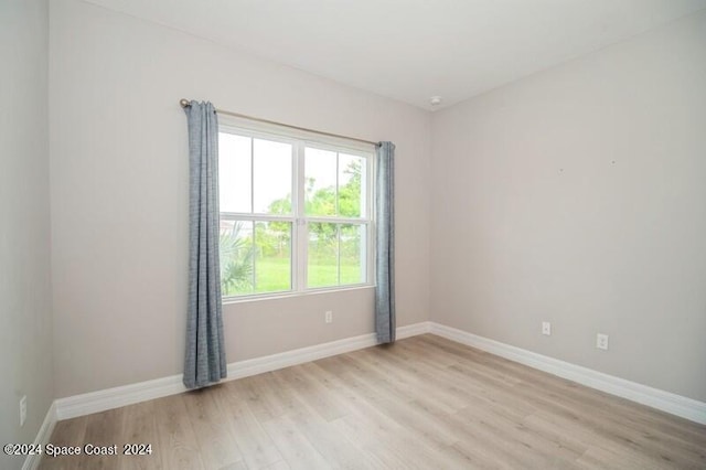 empty room with light hardwood / wood-style floors