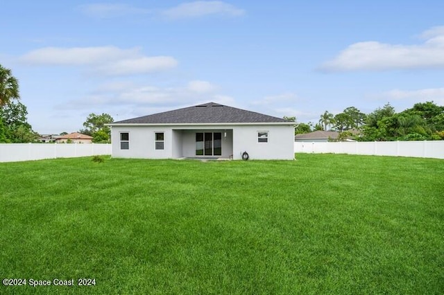 rear view of house with a lawn