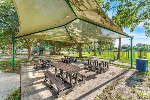 view of property's community featuring a lawn and a playground