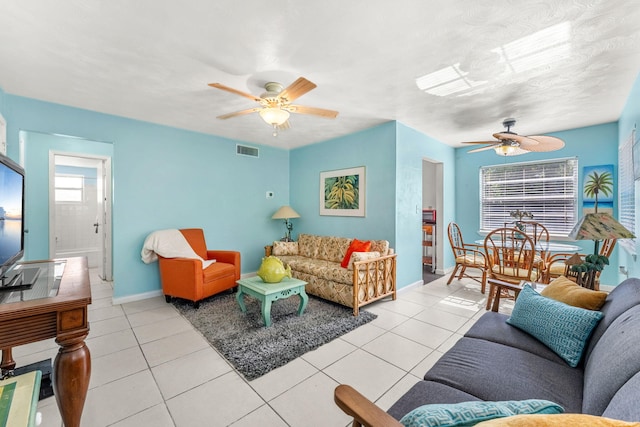 tiled living room featuring ceiling fan