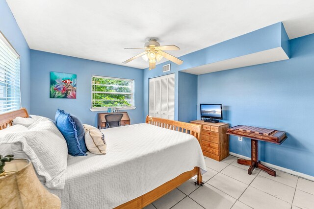 tiled bedroom featuring a closet and ceiling fan