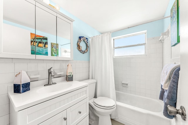 full bathroom with vanity, tile walls, decorative backsplash, shower / tub combo, and toilet