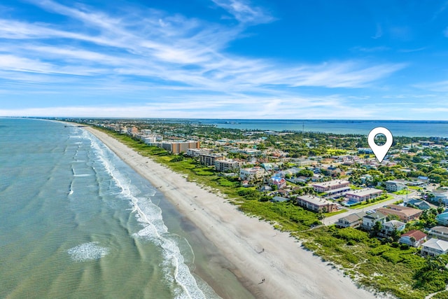 drone / aerial view with a water view and a beach view