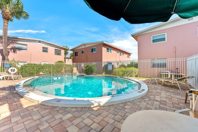 view of swimming pool featuring a patio area