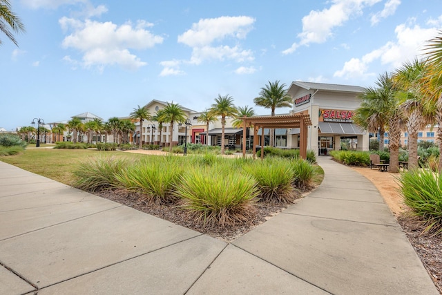 view of property's community with a lawn