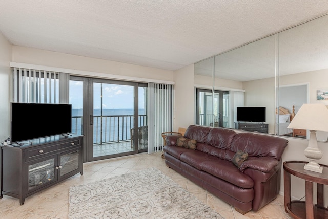 living room with light tile patterned floors and a textured ceiling