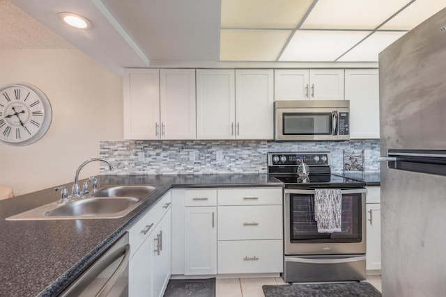 kitchen featuring white cabinetry, sink, tasteful backsplash, and stainless steel appliances