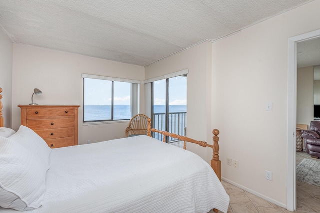 tiled bedroom with access to outside and a textured ceiling