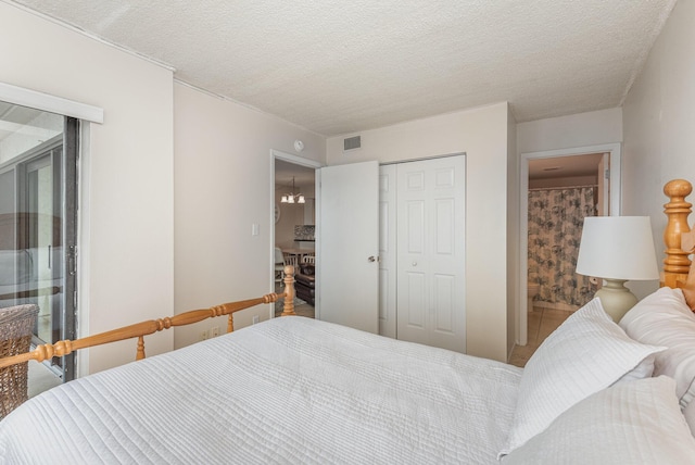 bedroom with a textured ceiling and a closet